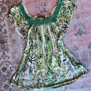 Whimsical witchy green babydoll top with lace detailing on the neckline